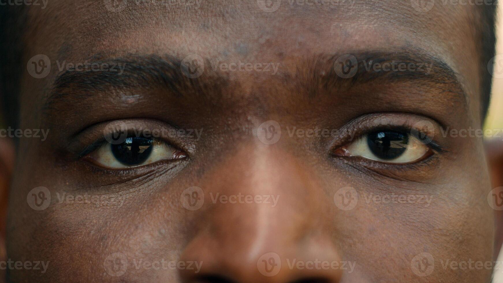 Close up cropped view detail ad male African American ethnic dark eyes close open blink ophthalmology eyesight see look vision sight eye problem strain ill sick facial expression looking laser surgery photo