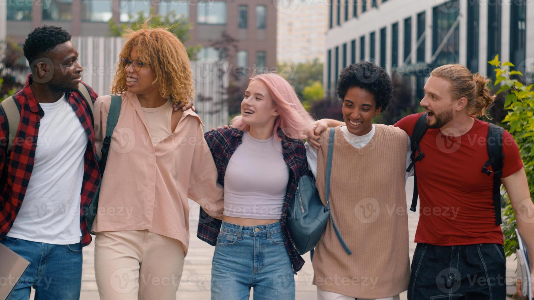 Happy smiling multiracial students diverse multiethnic diversity friends walking in city university college campus outdoors studying hugging together talking communicating laughing walk to lesson photo