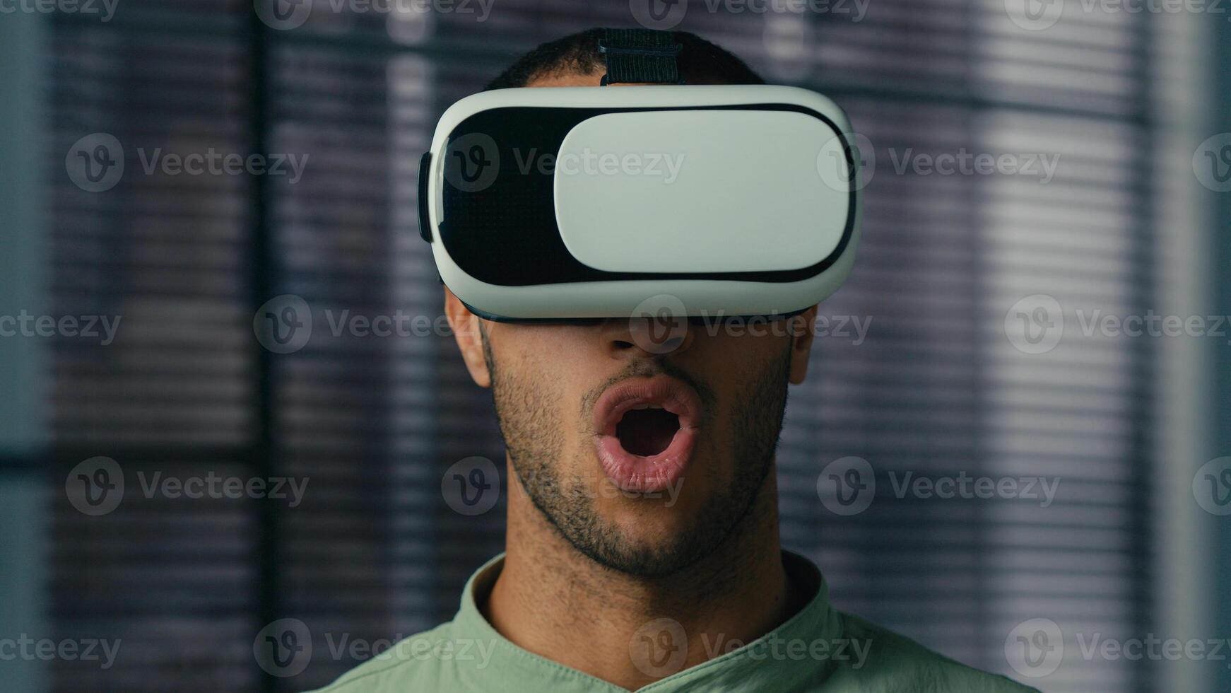 Surprised african american man take off VR glasses in 3D metaverse world play online male gamer enjoying game using virtual reality headset satisfied with modern innovative technology concept photo