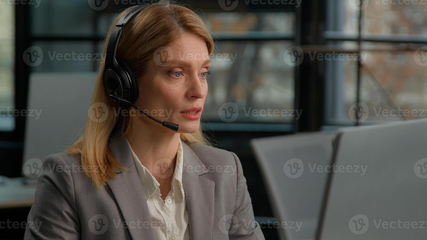 Caucasian middle-aged adult woman business female 30s businesswoman worker in office with headset using computer talking working customer support service operator helpline agent manager in headphones photo