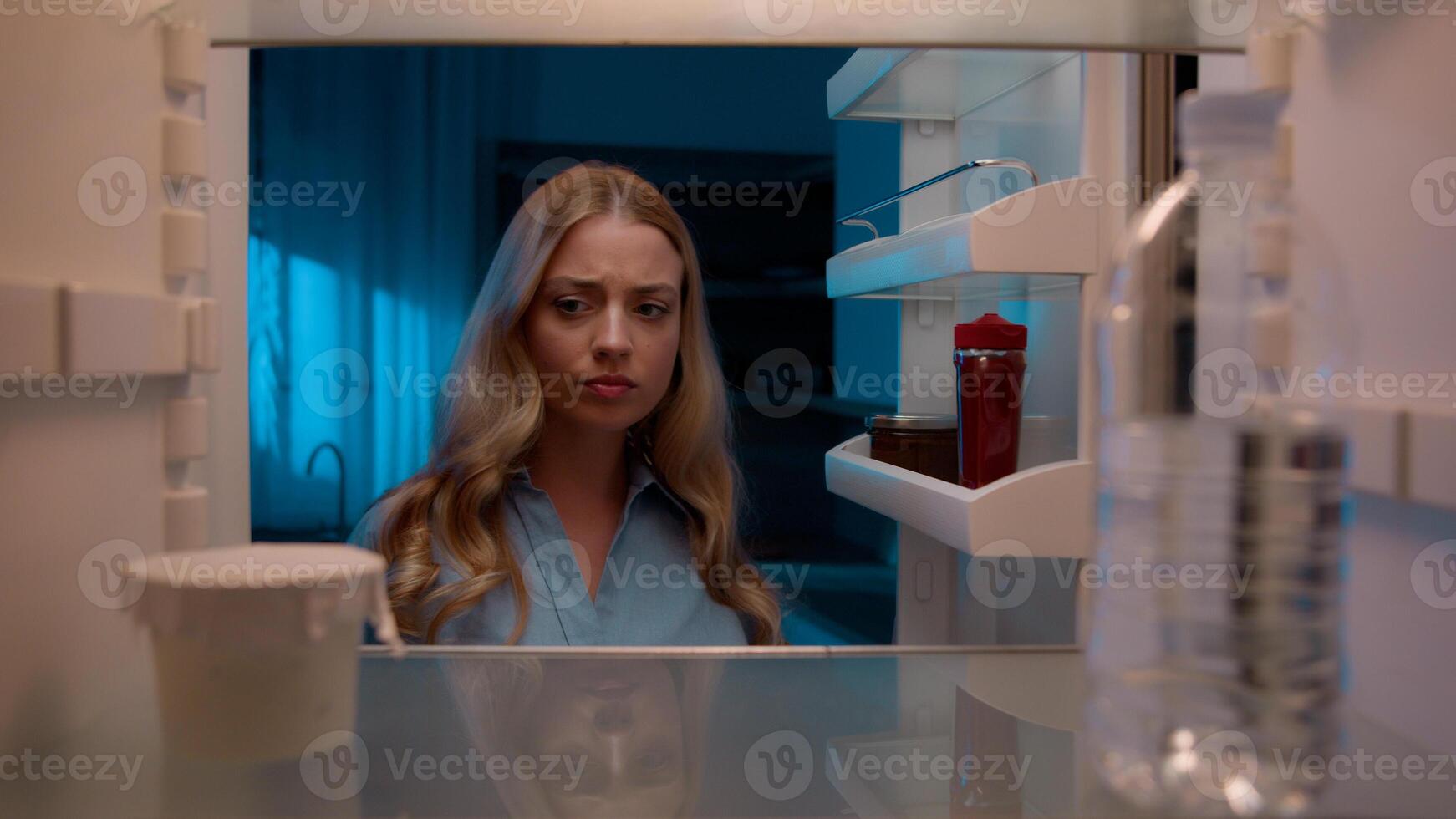 Point of view POV inside refrigerator Caucasian girl hungry woman open fridge at home kitchen look at empty shelves order food products delivery with mobile phone app online service web store shopping photo