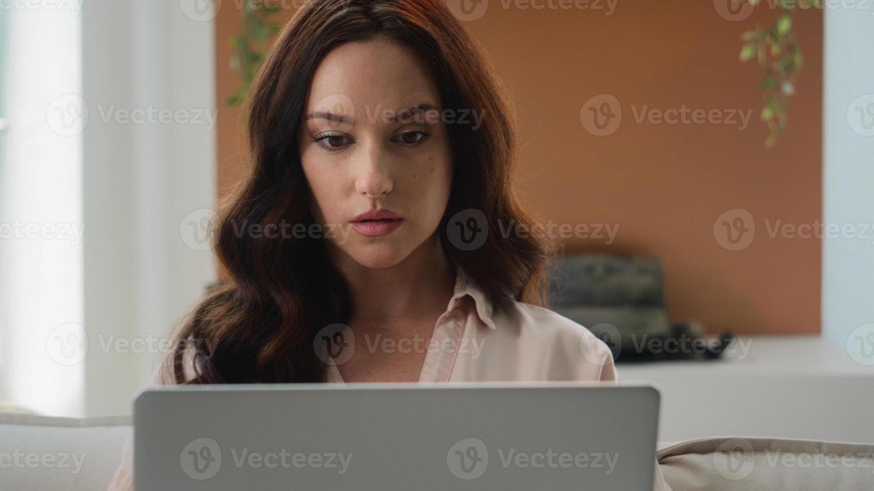 Focused Caucasian woman at home office looking at laptop girl use new app pensive thinking reading email work on research project online on computer make remote business task think of problem solution photo