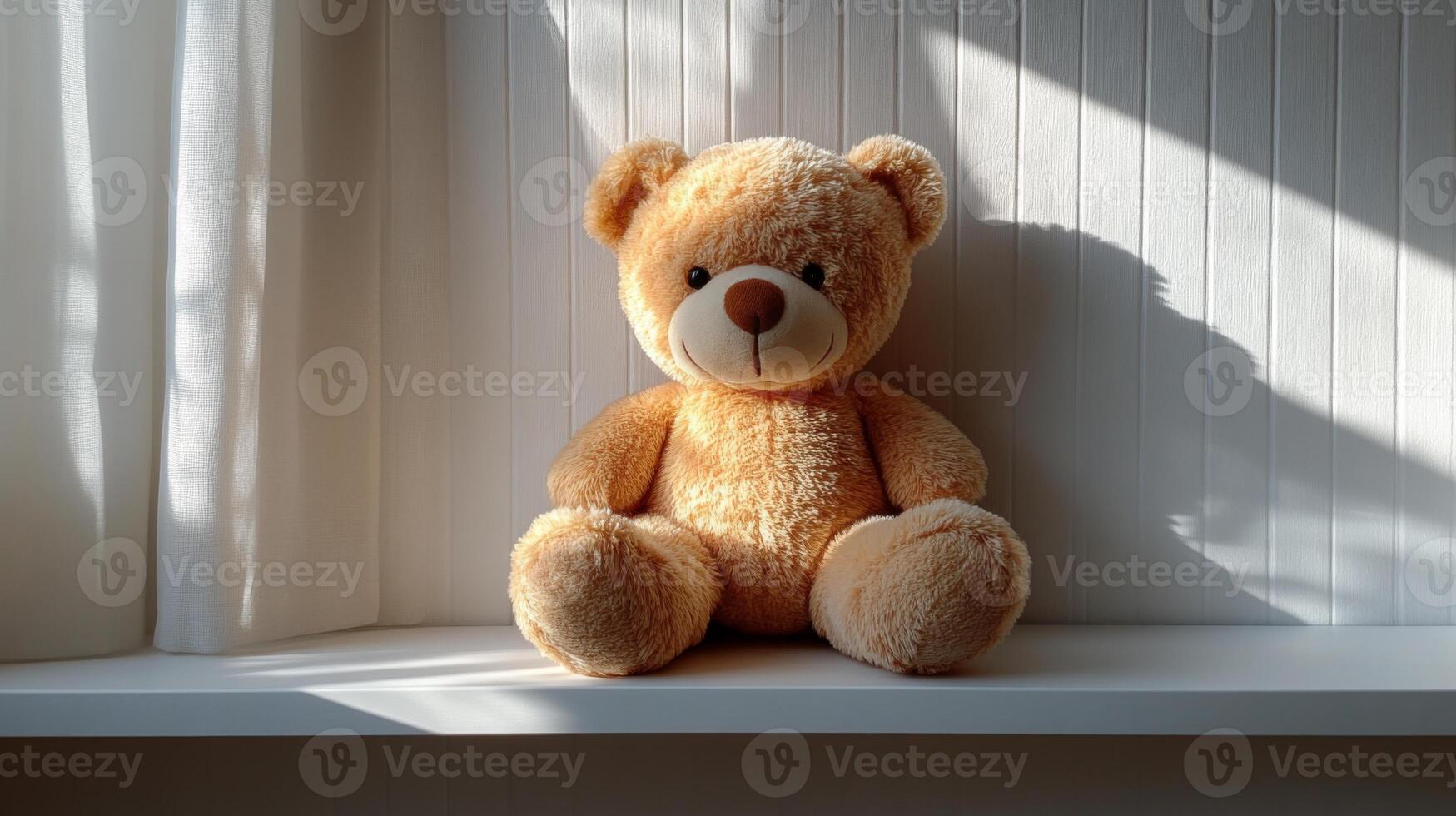A soft teddy bear is placed on a white window sill, basking in gentle morning sunlight. The warm rays create a comforting ambiance in the room. photo
