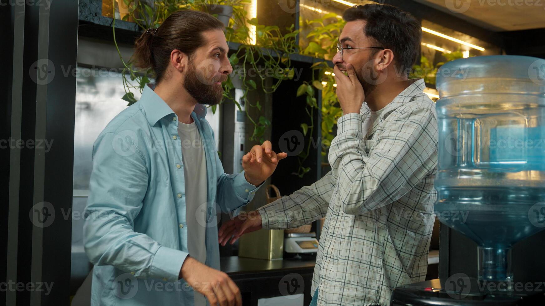 Diverse happy friends coworkers colleagues business men Arabian Indian Caucasian guys businessmen talking in bar office break sharing gossip secret on ear gossiping amazing news laugh male friendship photo