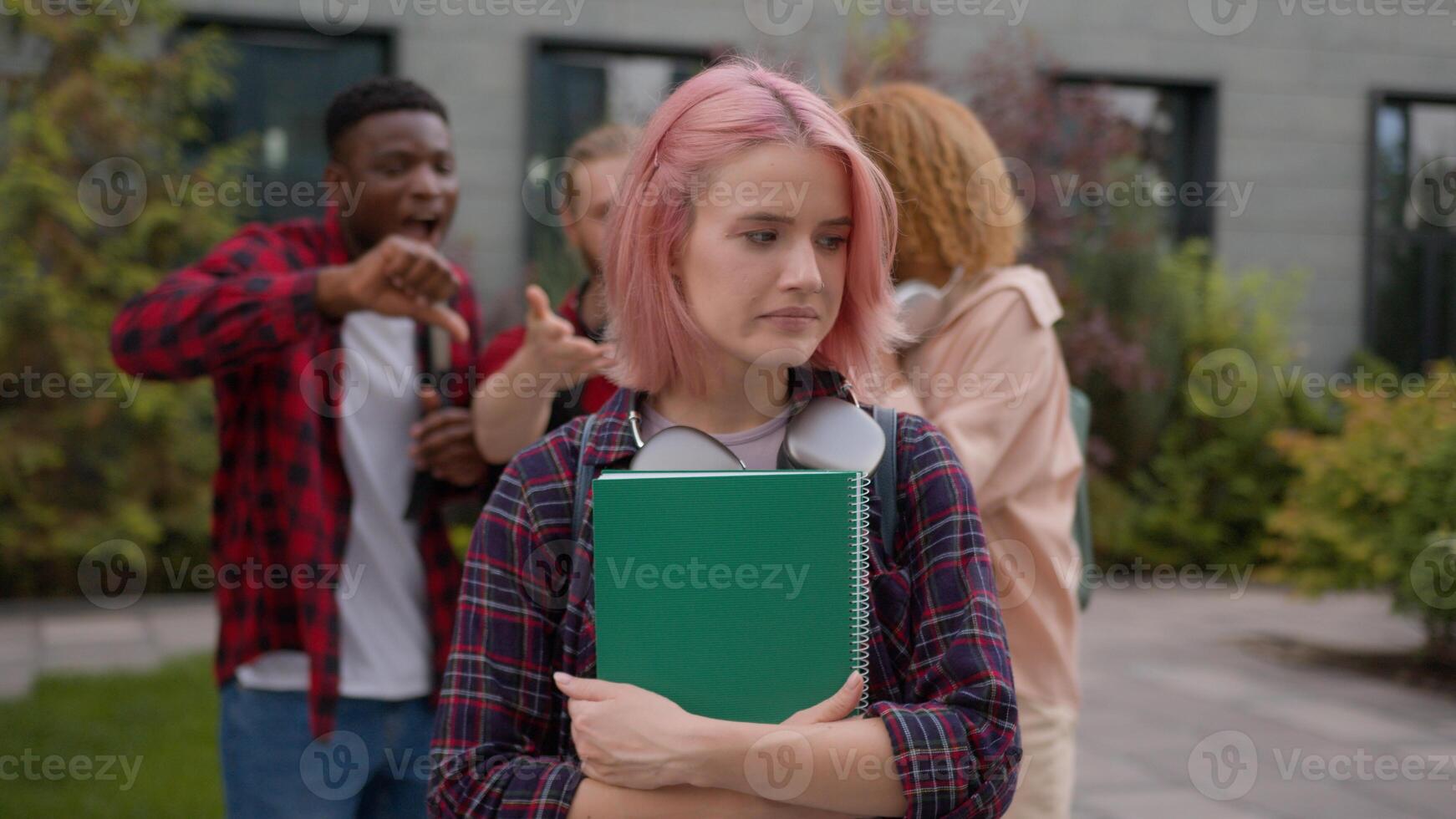 Sad stressed scared offended school girl student woman informal hipster with pink hair suffer aggressive multiracial students classmates mock abused humiliate bully mockery bullying university racism photo