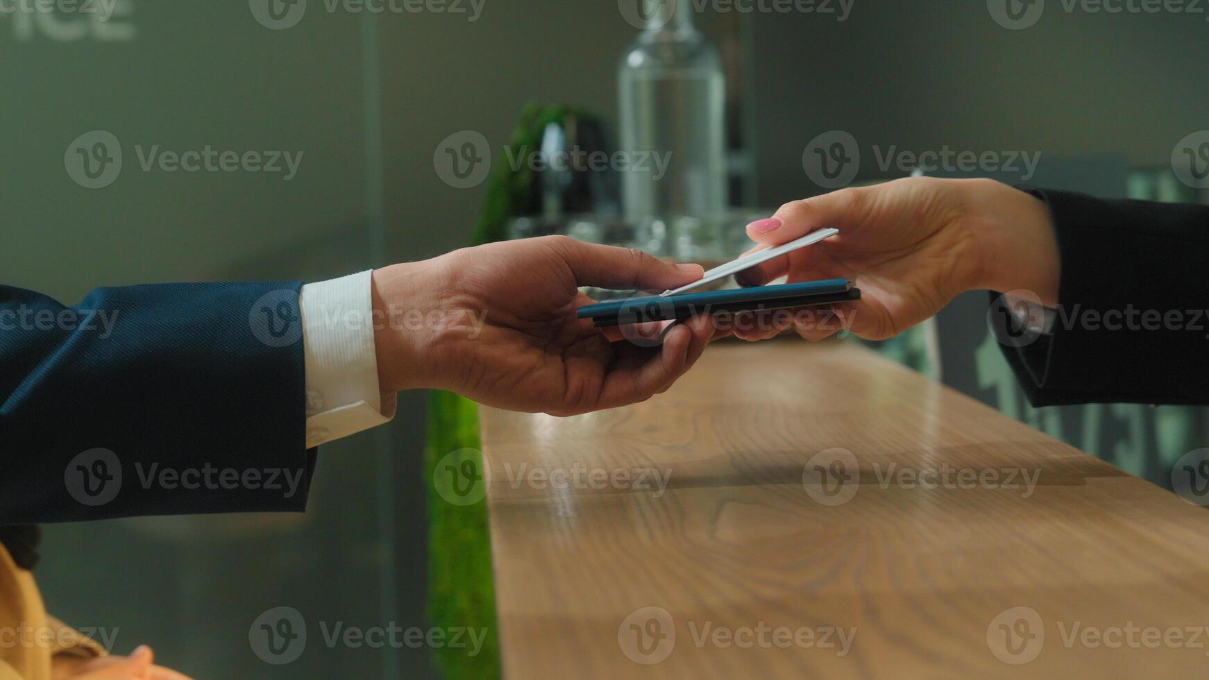 Close up hands give passports documents hotel reception couple man woman passengers tourists travelers booking room reserve apartment arrive resort travel trip tourism service concierge give key card photo