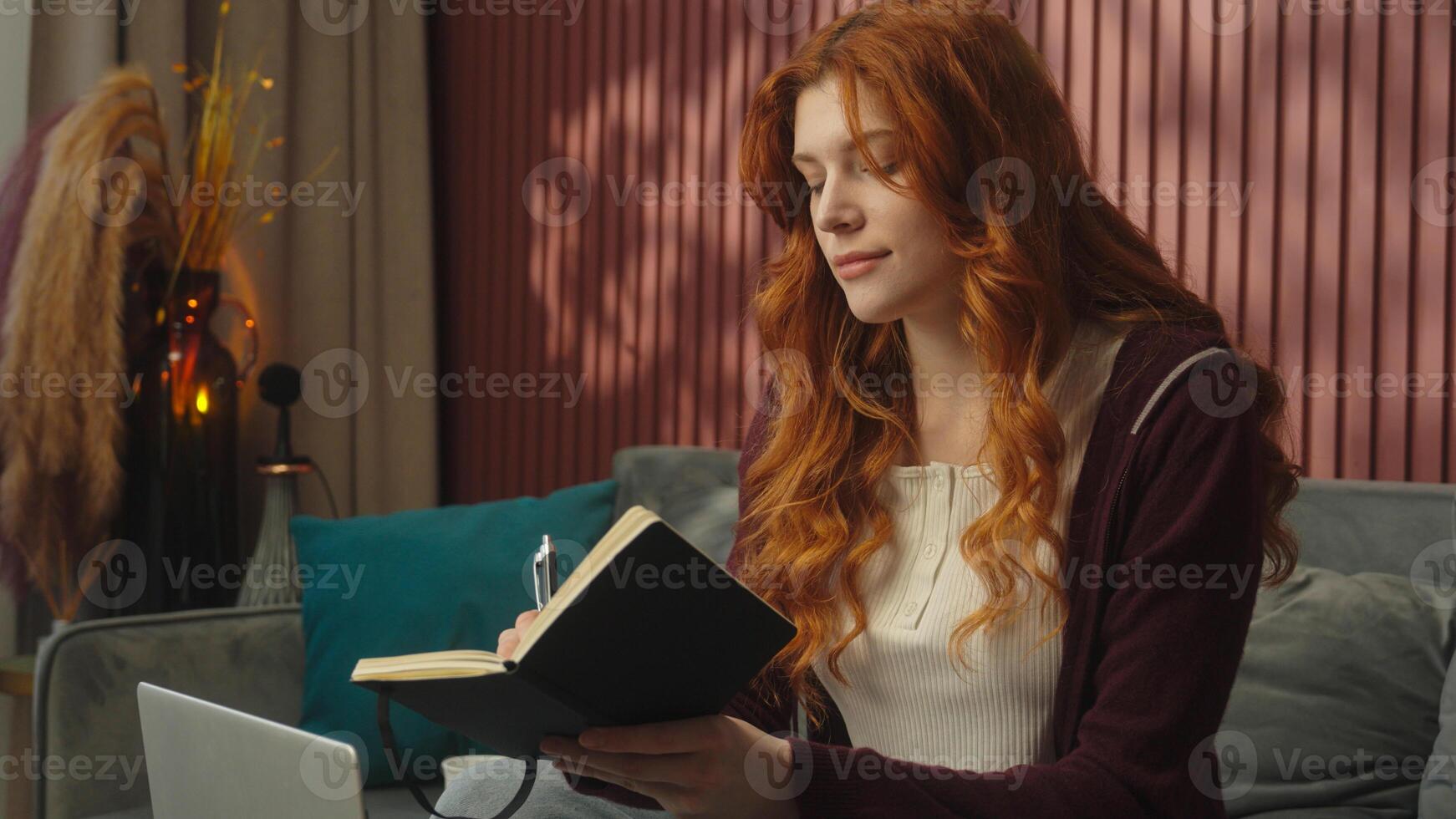 Caucasian woman at home writing notes drink coffee working from home student girl online studying e-learning homework write notebook exam tasks female businesswoman remote work typing laptop computer photo