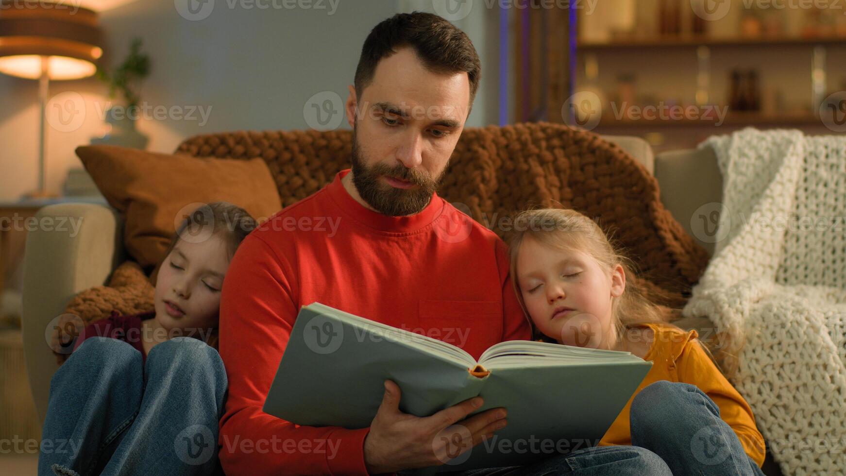 Caucasian dad parent man babysitter read book for kids at evening home caring father telling little preschool girls reading night fairy tale sleeping daughters affectionate family children education photo