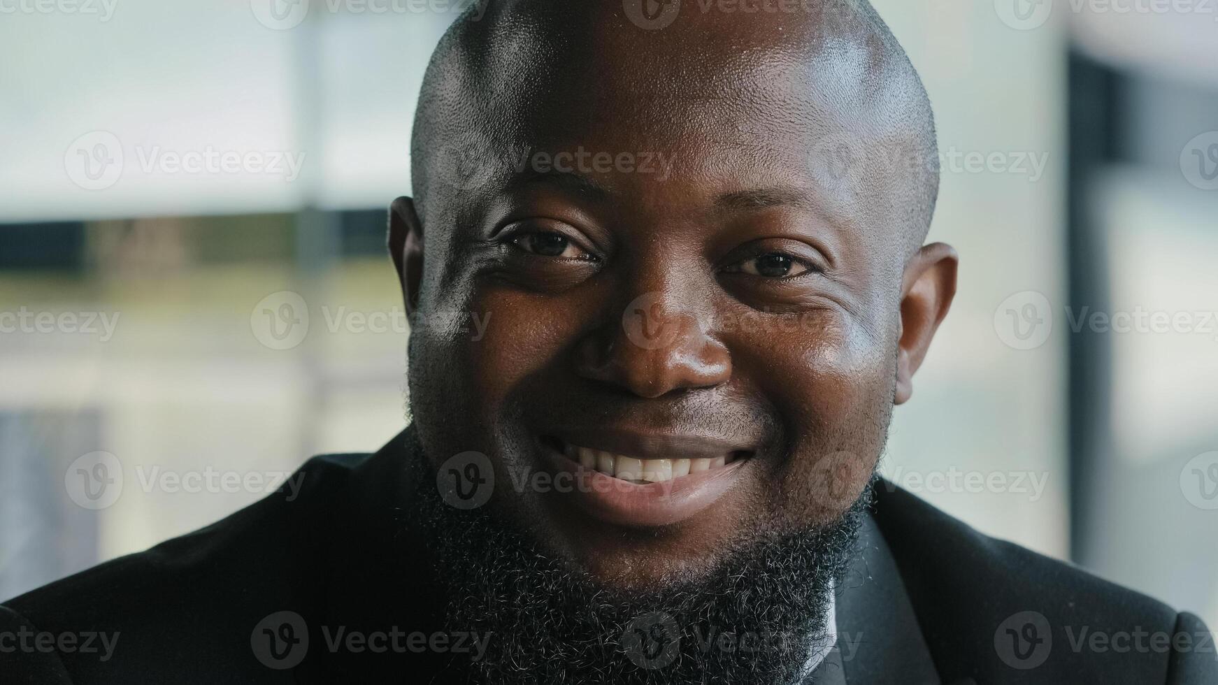 Friendly millennial african american bearded plus size man lawyer businessman ceo manager entrepreneur office clerk optimistic joyful male with happy face posing alone in workspace close up portrait photo