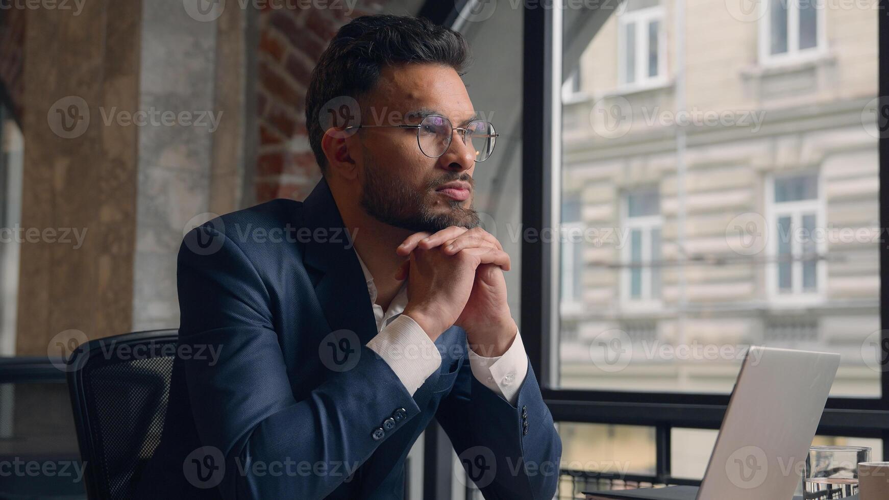 Pensive thoughtful puzzled male business man Arabian guy Indian businessman serious employer office manager entrepreneur think idea thinking planning solution ponder decision workspace coworking cafe photo