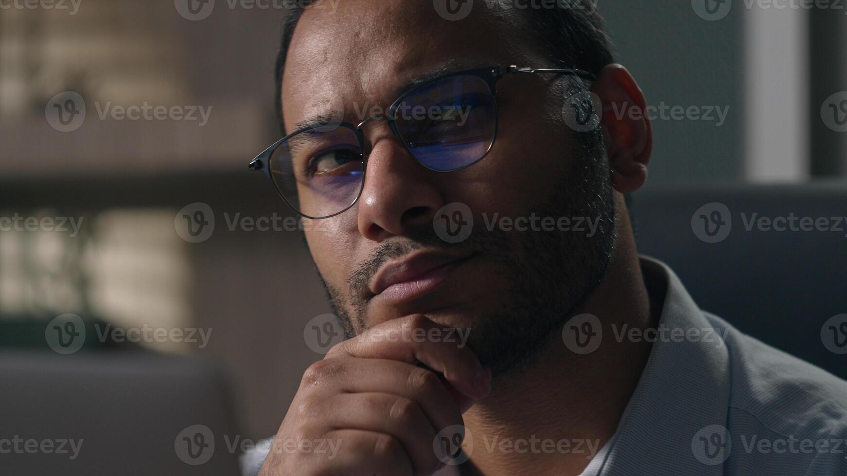 Close up Indian man in glasses Arabian businessman with laptop thinking holding chin pensive thoughtful employer think pondering idea solving problem solution working computer creative planning ponder photo