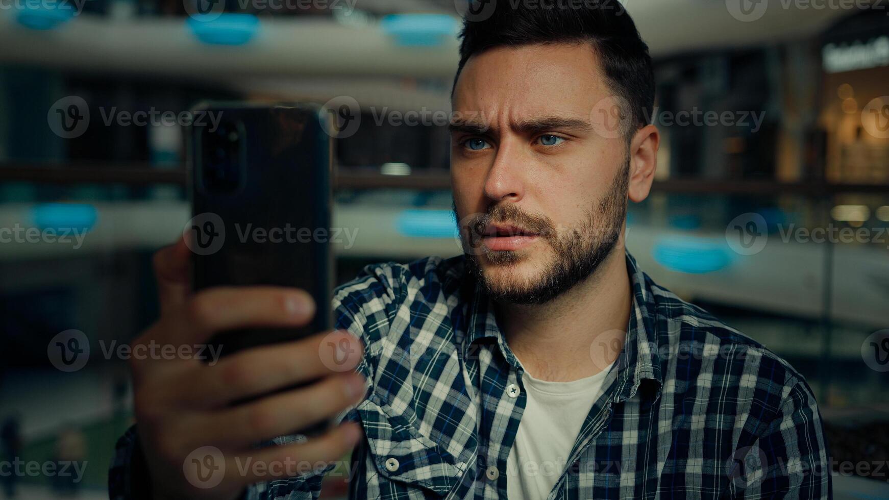 Millennial blogger caucasian hispanic man businessman business consultant speak mobile phone via digital webcam app on smartphone talk online friend business cell telecommunication use wi-fi network photo