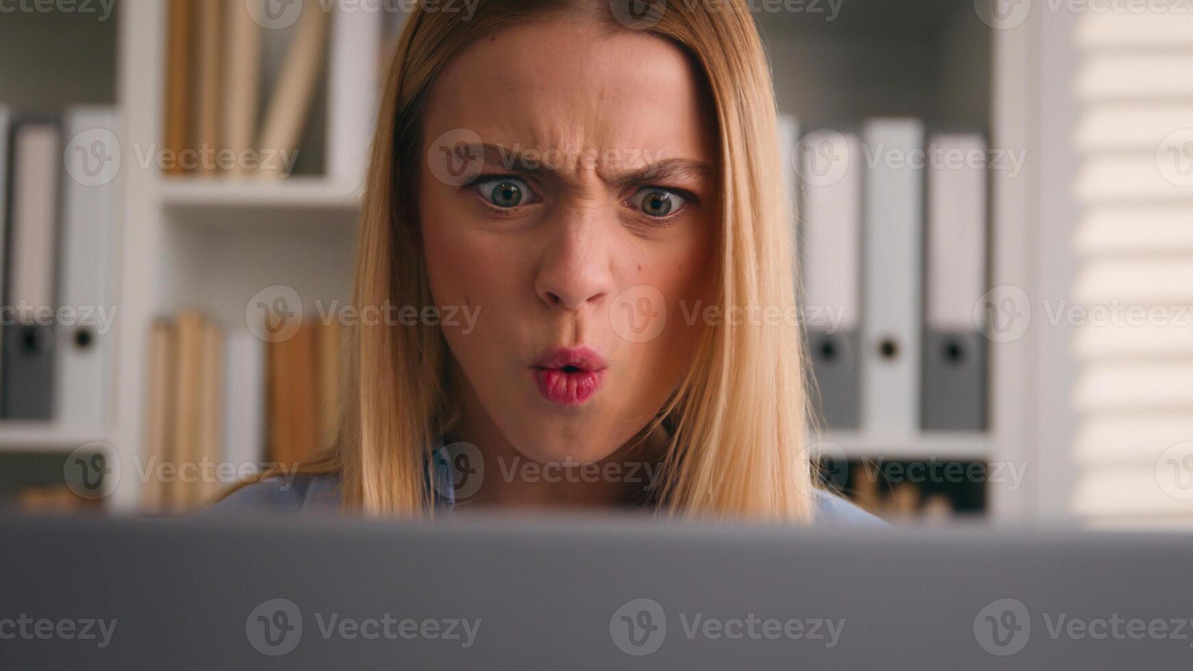 Close up angry upset Caucasian woman user using laptop in home office frustrated mad confused shocked computer problem say what shock failure online stressed girl businesswoman mistake software error photo