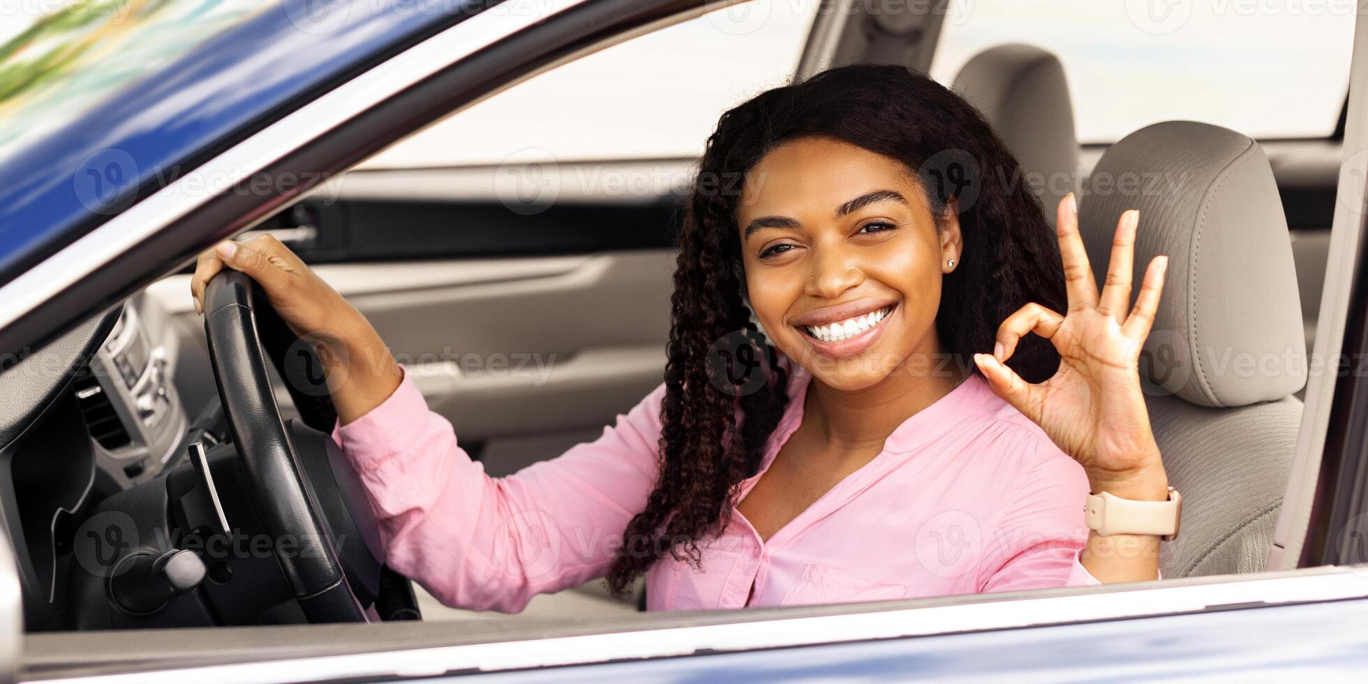 Great Perfect Car. Happy African American Woman Showing Okay Sign Gesture, Sitting In New Automobile Buying Modern Vehicle In Dealership Store, Enjoying Vacation, Looking At Camera Through The Window photo
