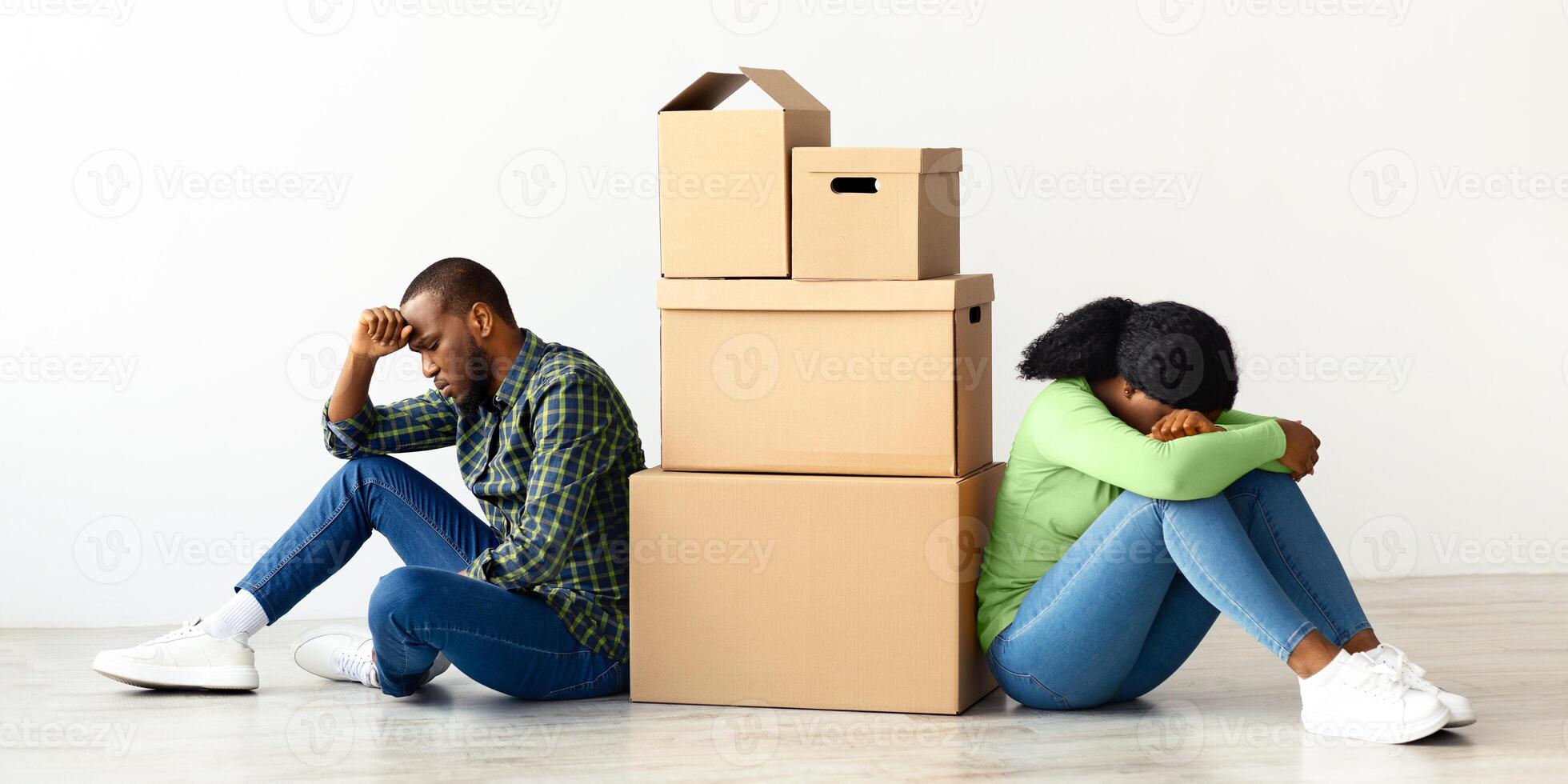 Conflicts During Moving. Sad Black Spouses Sitting Next To Cardboard Boxes In New Flat, Tired African American Couple Suffering Problems With Relocation, Thinking About Divorce, Copy Space photo