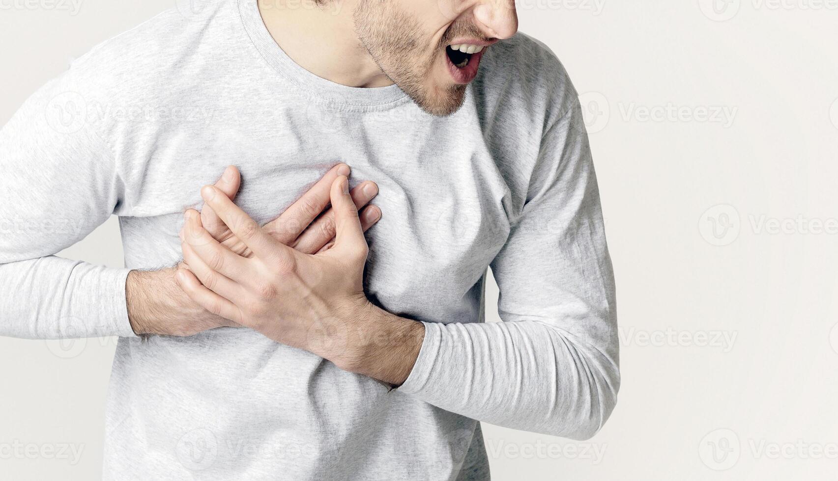 Heart attack concept. Man screams in pain, free space photo