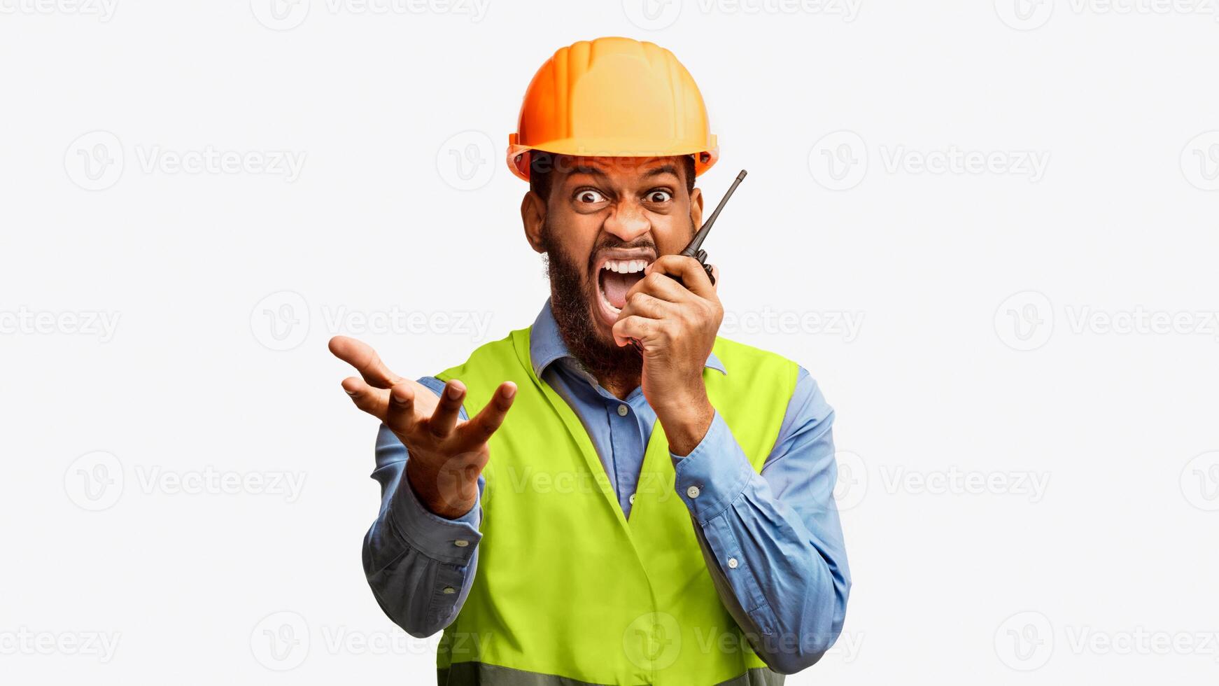Building Industry. Mad Black Architect In Helmet And Vest Shouting In Two-Way Radio On White Studio Background, Looking At Camera photo