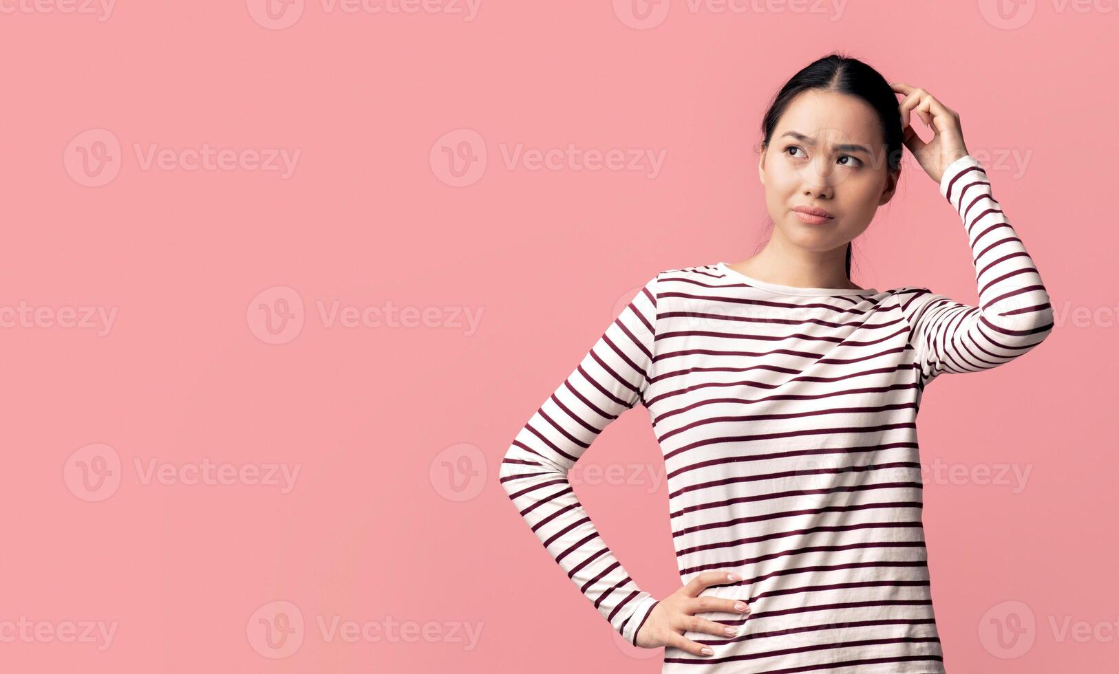 Difficult Choice. Puzzled Asian Lady Touching Head And Looking At Copy Space, Doubtful Confused Young Korean Woman Thinking About Offer While Standing Isolated Over Pink Background, Panorama photo