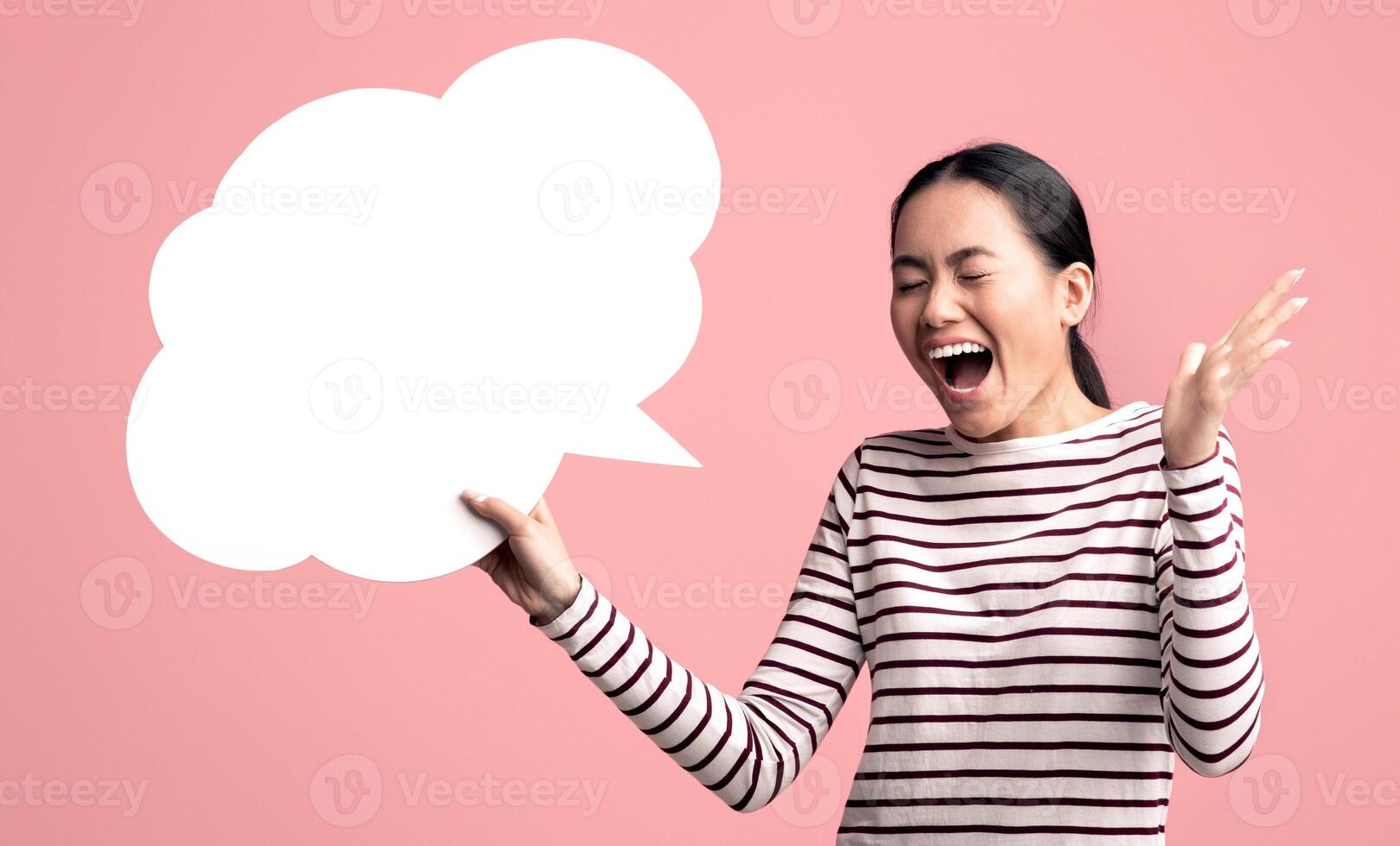 Happy Surprised Asian Woman Holding Blank Speech Bubble And Exclaiming With Excitement, Cheerful Young Korean Lady Emotionally Reacting To Nice Offer While Standing On Pink Background, Copy Space photo
