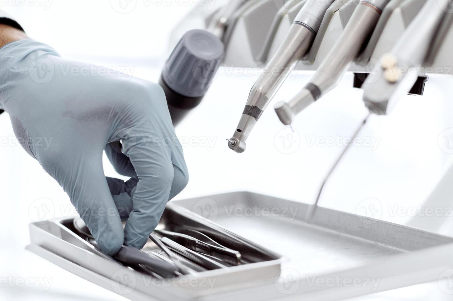 Closeup Shot Of Dentists Hand In Blue Glove Taking Sterile Stomatological Tools Out Of Case Before Dental Treatment In Modern Clinic, Unrecognizable Doctor Using Professional Medical Equipment photo