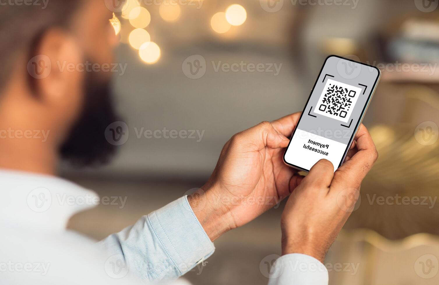 QR code on mobile phone screen, closeup. Unrecognizable african american man holding modern smartphone with bar code, paying for goods and services with payment system, creative image photo