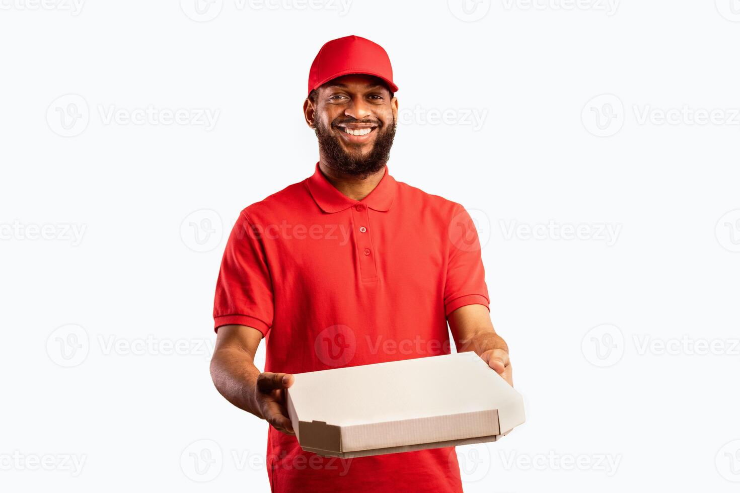 African Courier Guy Delivering Pizza Box Standing In Studio On Yellow Background. Pizzeria Delivery Service. photo