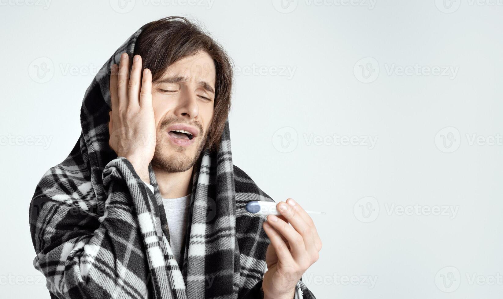Desperate man sees high temperature on electronic thermometer, empty space photo