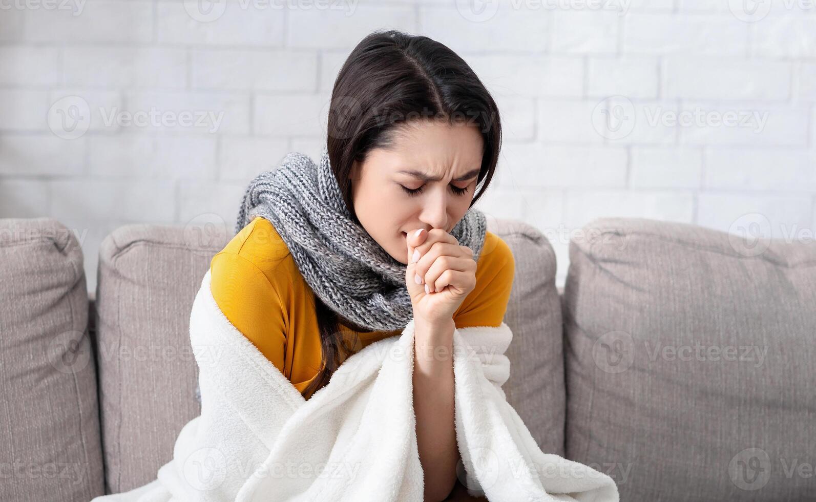 Unhealthy young lady suffering from virus, coughing into her hand at home. Panorama photo