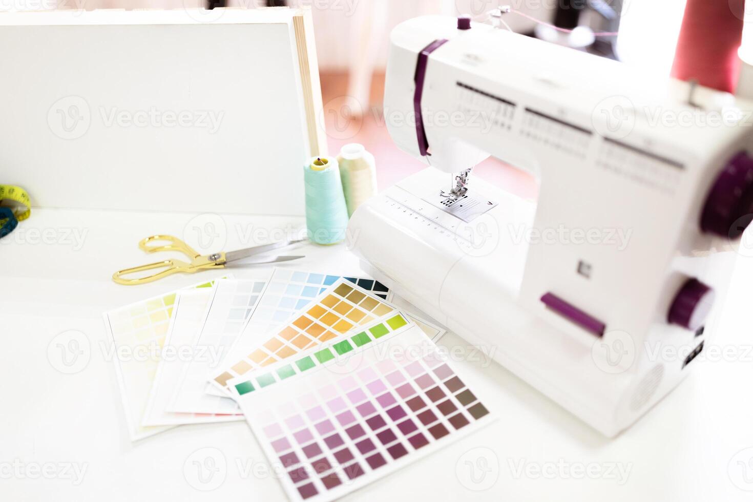 Tools like scissors and a sewing machine are neatly arranged on the table, showcasing creativity. photo
