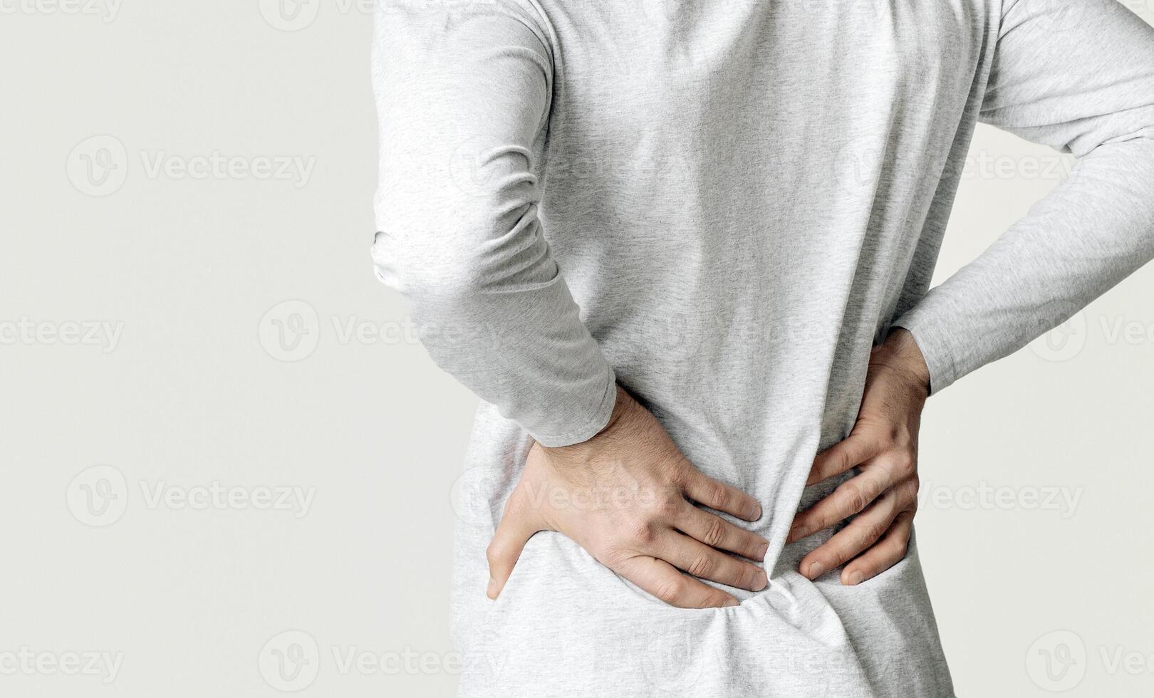 Kidney pain concept. Man presses hands to his back, panorama photo