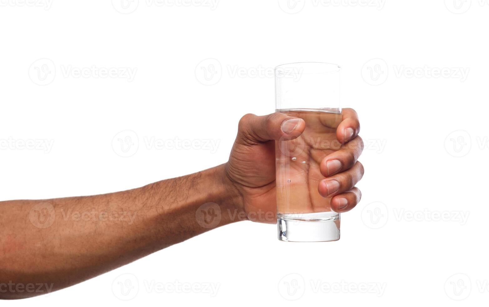 Black male hand holding glass of water isolated on white background, closeup, cutout photo