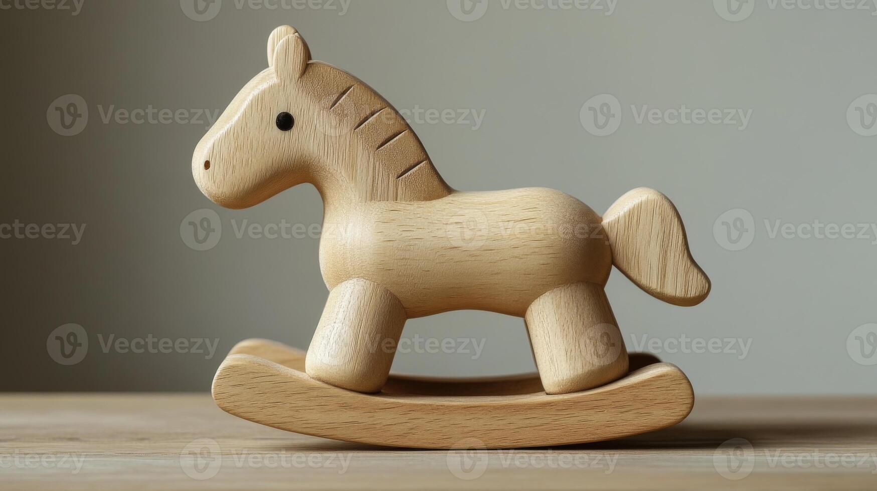 A detailed wooden rocking horse toy sits on a clean surface, exemplifying a classic design meant for children's play. The craftsmanship highlights natural materials and simplicity. photo