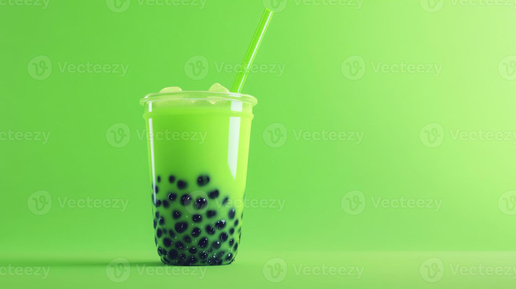 A vibrant green drink filled with large tapioca pearls sits on a bright green background. The cup is clear, showing the refreshing beverage inside, complete with ice and a straw. photo