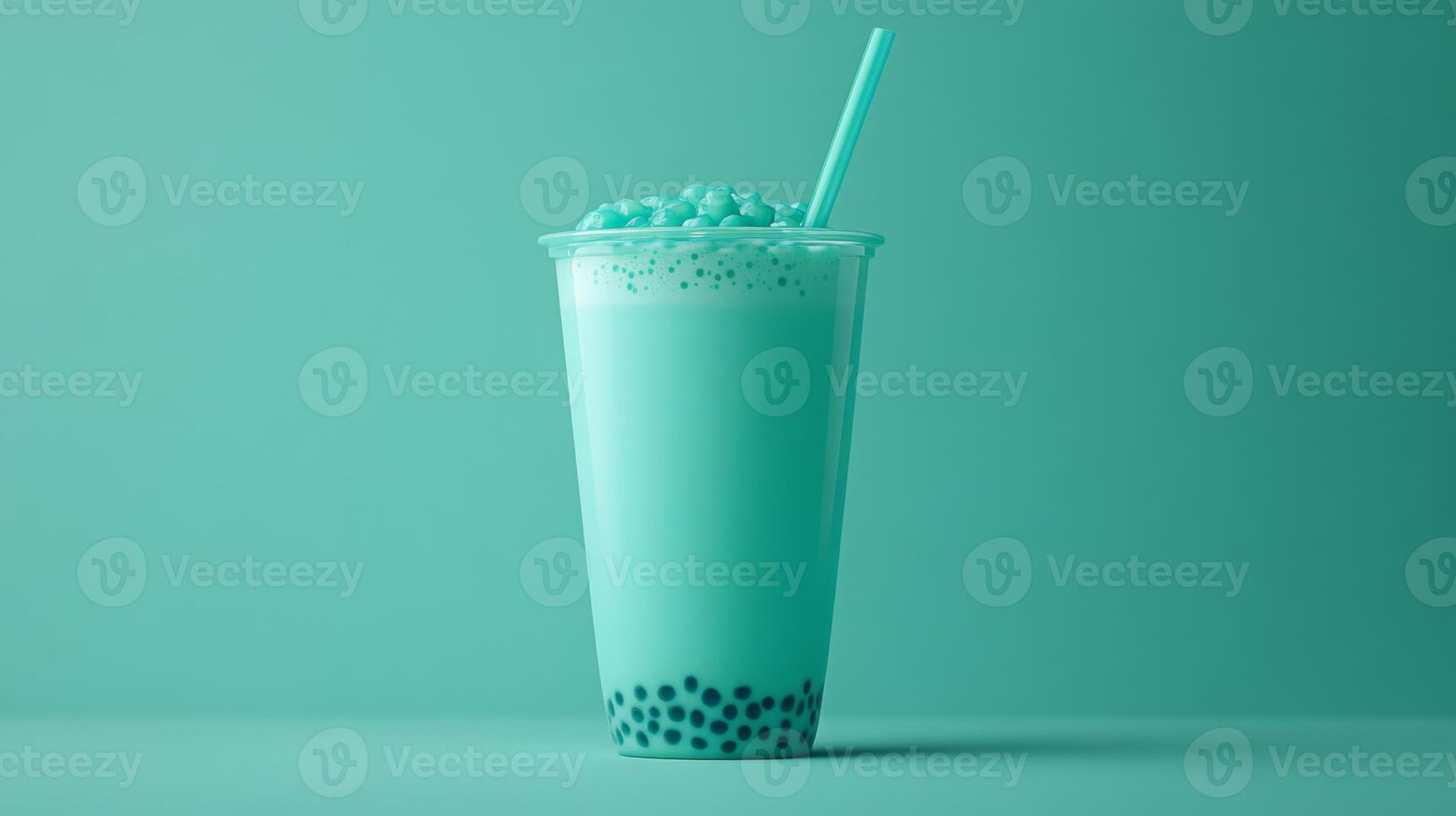 A clear cup filled with refreshing mint bubble tea showcases chewy tapioca pearls at the bottom. photo