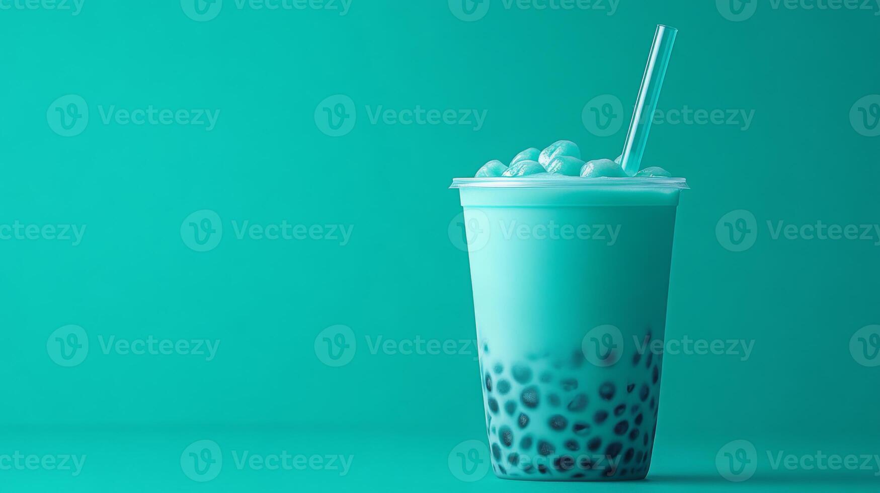 A vibrant teal bubble tea filled with chewy tapioca pearls is served in a clear cup. A straw is inserted, and the drink is set against a solid turquoise backdrop, creating an inviting look. photo