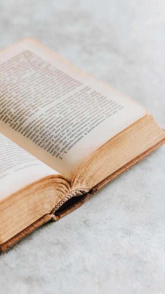 Old open book resting on a wooden surface with soft lighting and natural textures photo