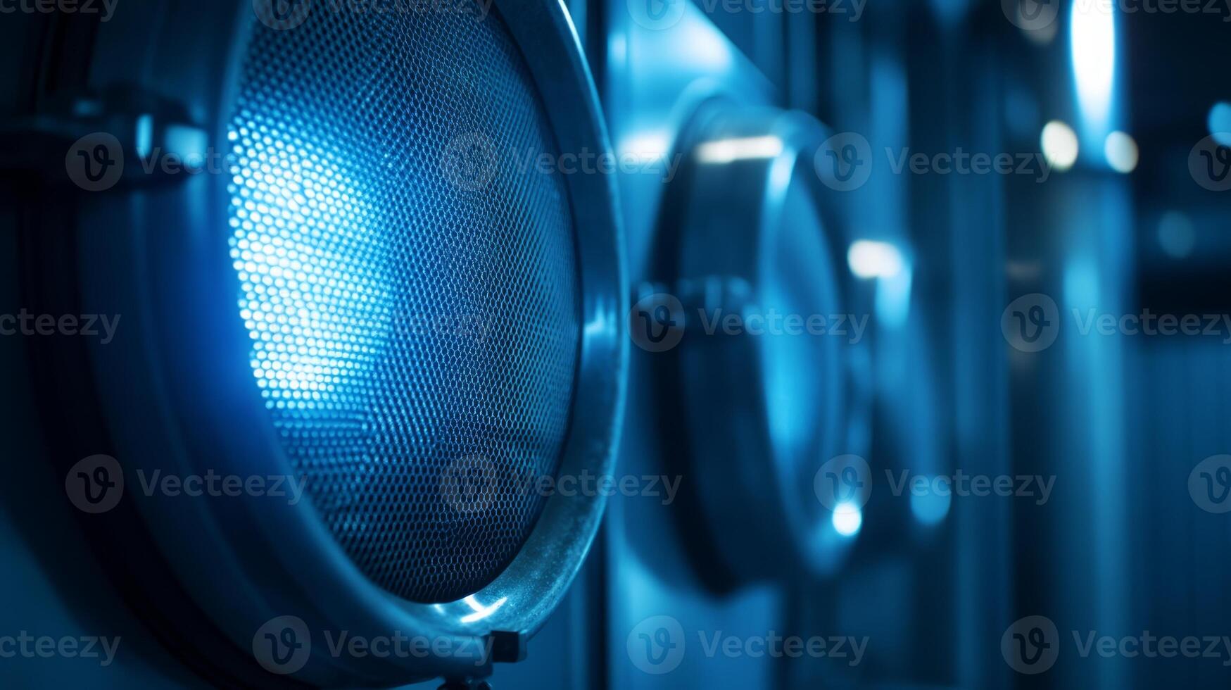 Close-up of industrial equipment featuring circular panels with blue lighting. photo