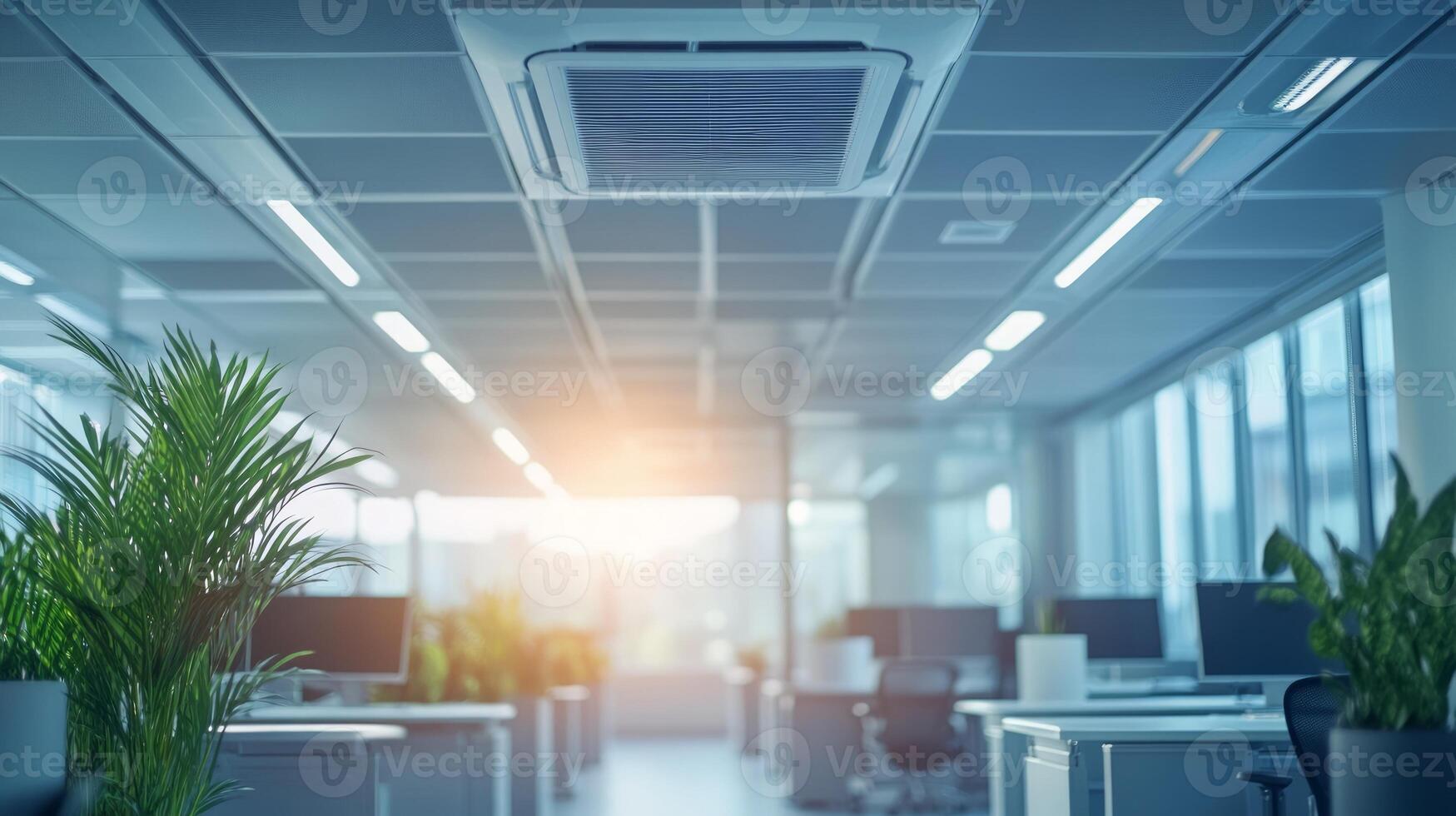 Modern office interior with air conditioning, plants, and computer workstations. photo