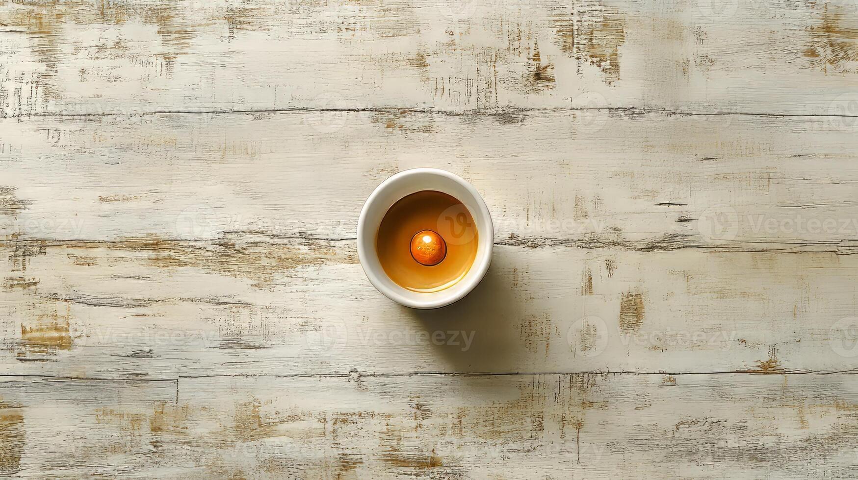 An egg in a bowl on a wooden table photo