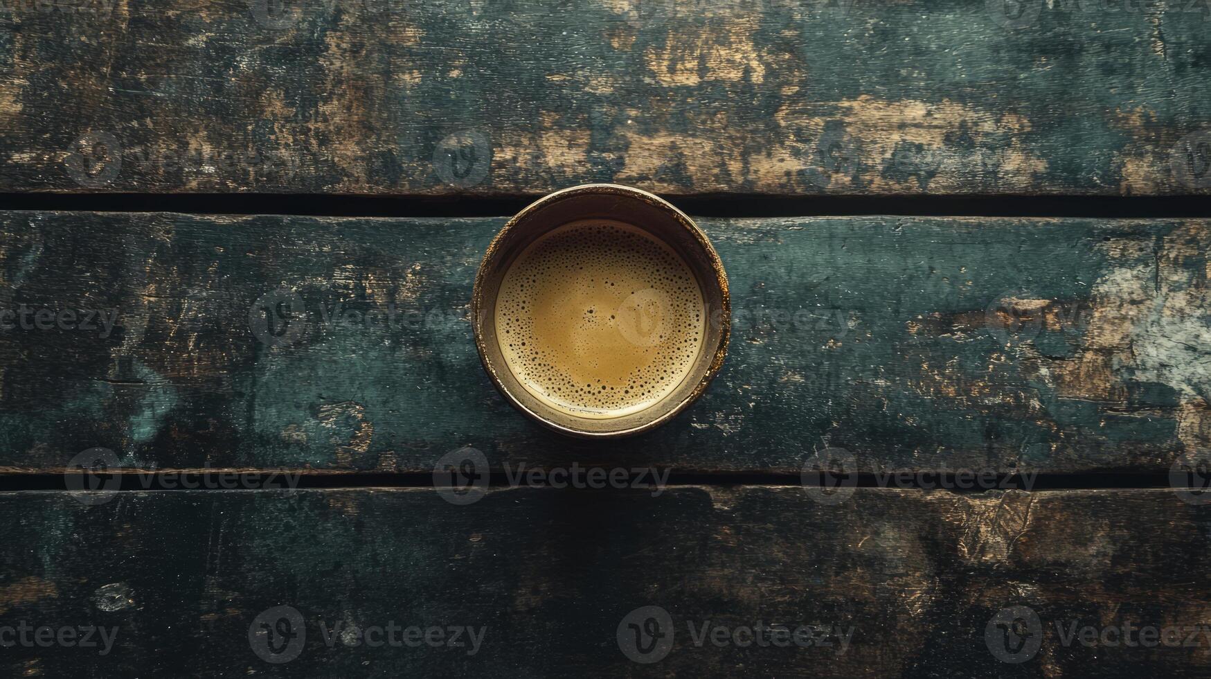 A golden cup on a wooden table photo