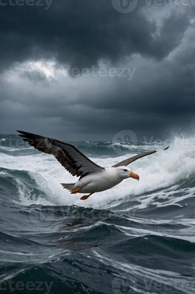 A seagull glides over turbulent ocean waves beneath a stormy sky. photo
