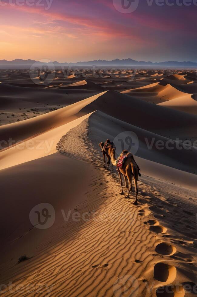 A serene desert landscape at sunset with camels walking along the sandy dunes. photo