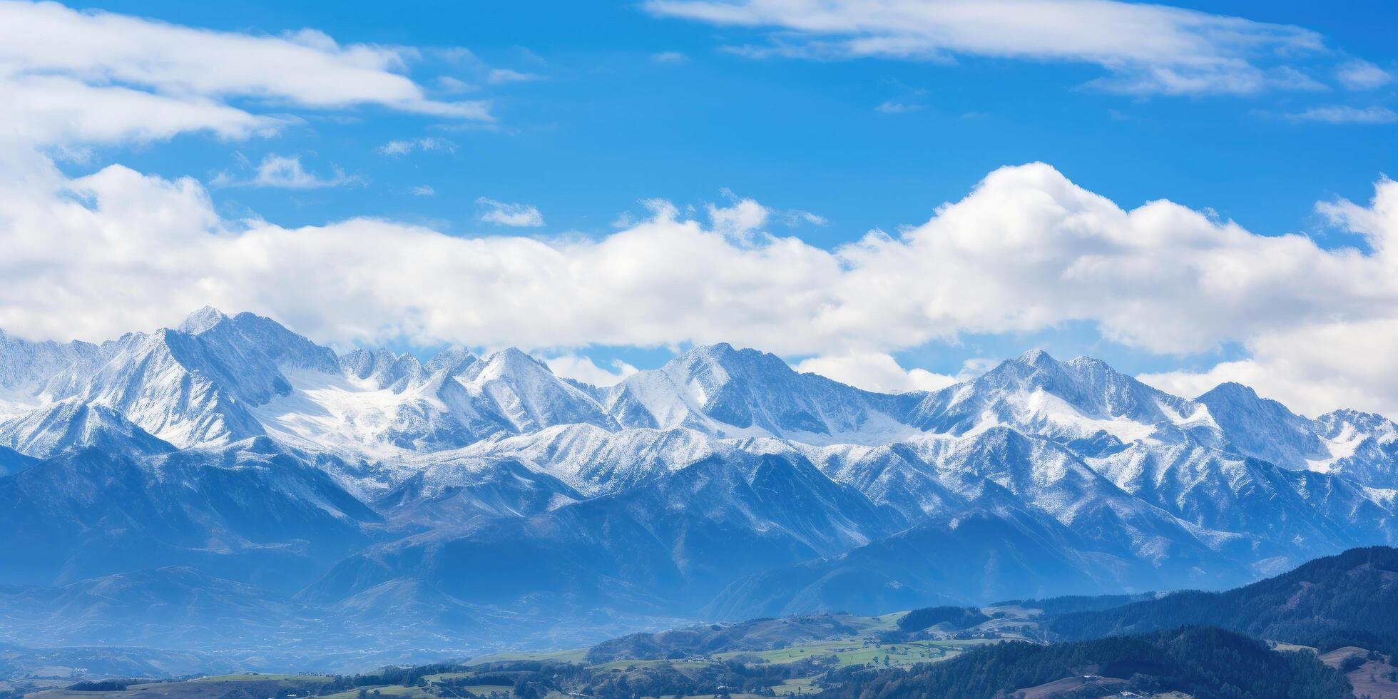 Majestic snow capped mountain peaks under a blue sky photo