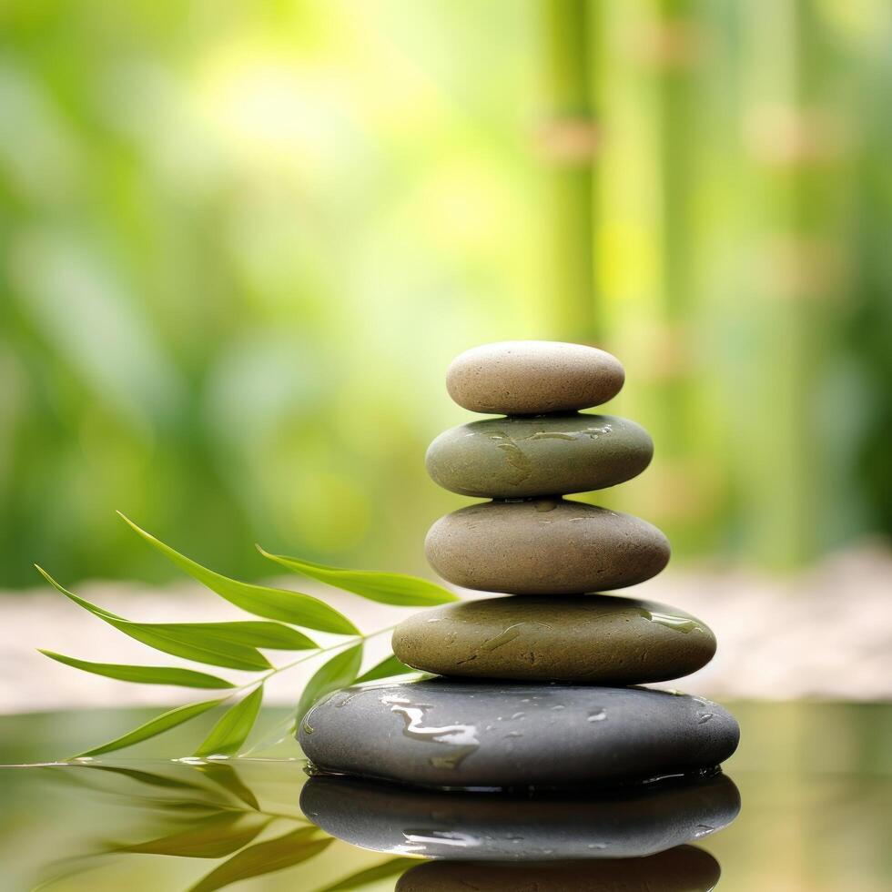Zen garden with stacked stones and bamboo leaves photo
