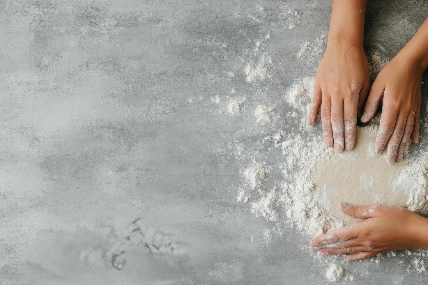 Making dough on a clean surface with hands covered in flour during baking preparation photo