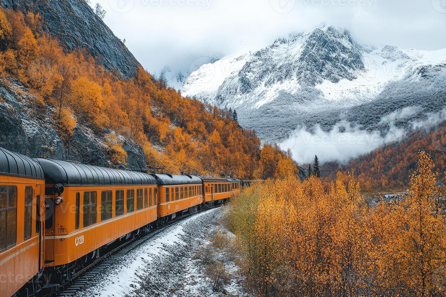 Train moving through colorful autumn forest and snowy mountains in alaska photo