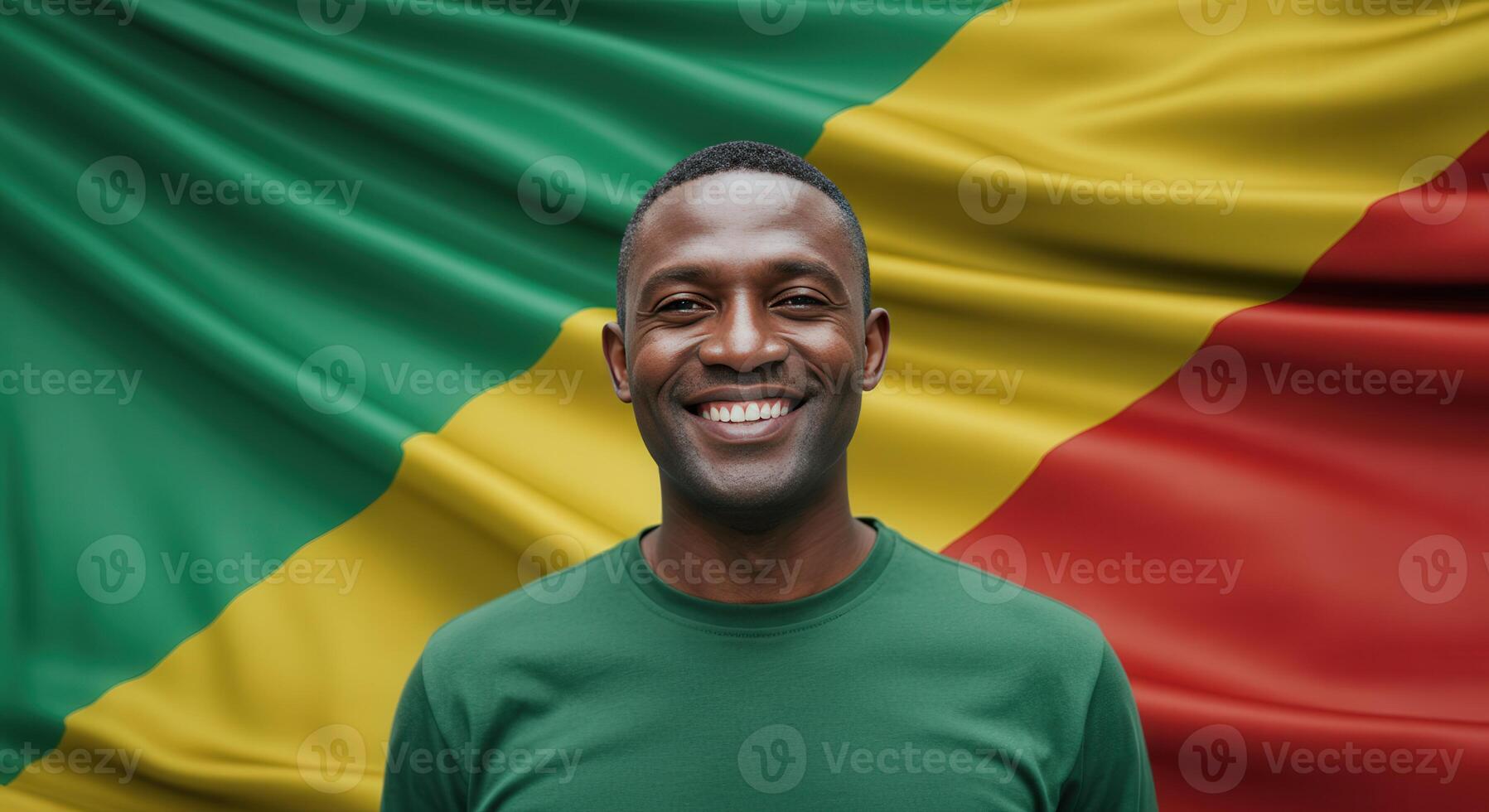 Portrait of a smiling man in green shirt in front of african flag for cultural diversity concept photo