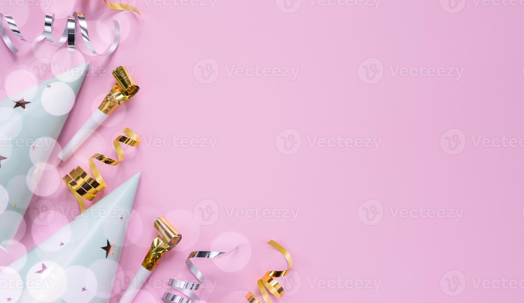 Party hats and and party decor on a pink background. Holidays concept. Copy space. Top view. Flatlay. photo