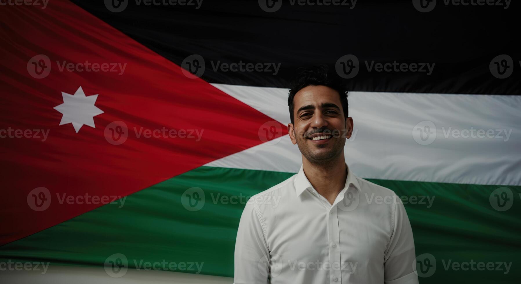 Confident young man in white shirt standing in front of jordanian flag photo