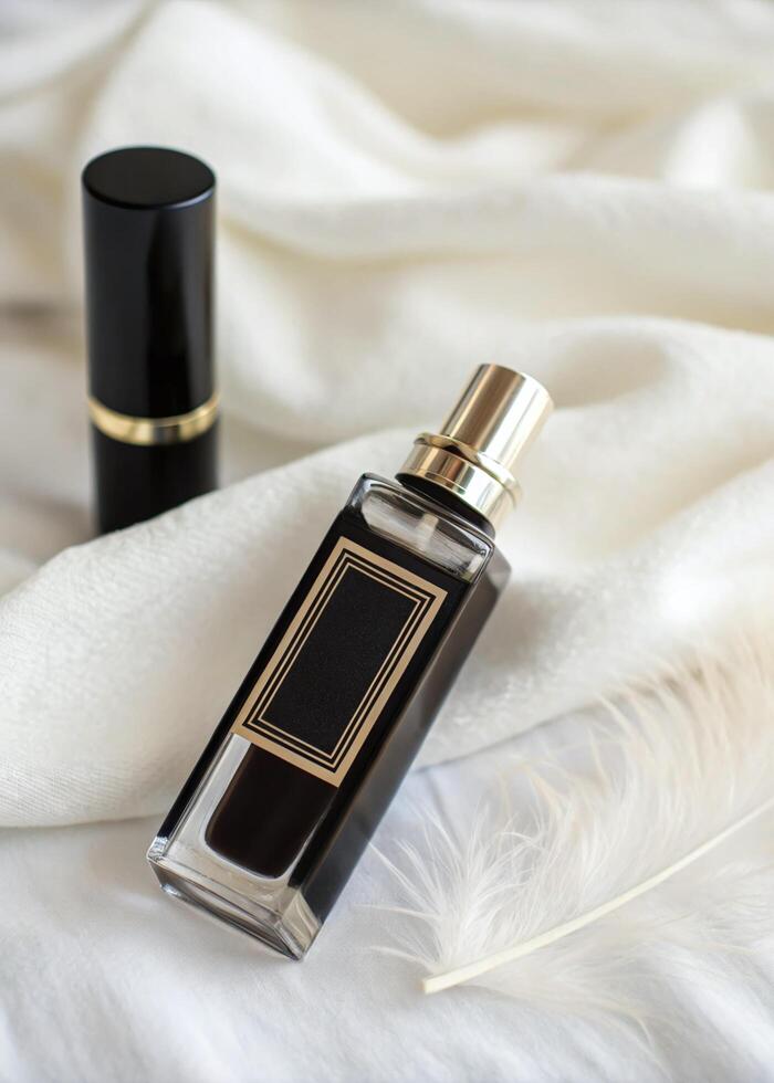 Elegant Perfume Bottle and Lipstick on White Fabric with Feather photo